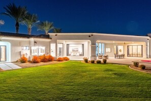 A modern house with a well-maintained lawn, outdoor seating, and large windows. - $5M PV Estate|Casita|Camelback View|Sleeps 16 (Paradise Valley)