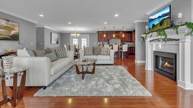 A modern living room with a fireplace, a dining area, and a kitchen in the background. - Ellicottville Chalet & Cottage 5 Mi to Village (Salamanca)