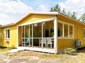 A yellow single-story house with a covered porch, large windows, and a small front yard. - 4 Star Holiday Home in Solvesborg (Sölvesborg)