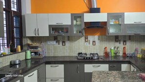 Une cuisine équipée d’une cuisinière à gaz, de placards et d’un four à micro-ondes.