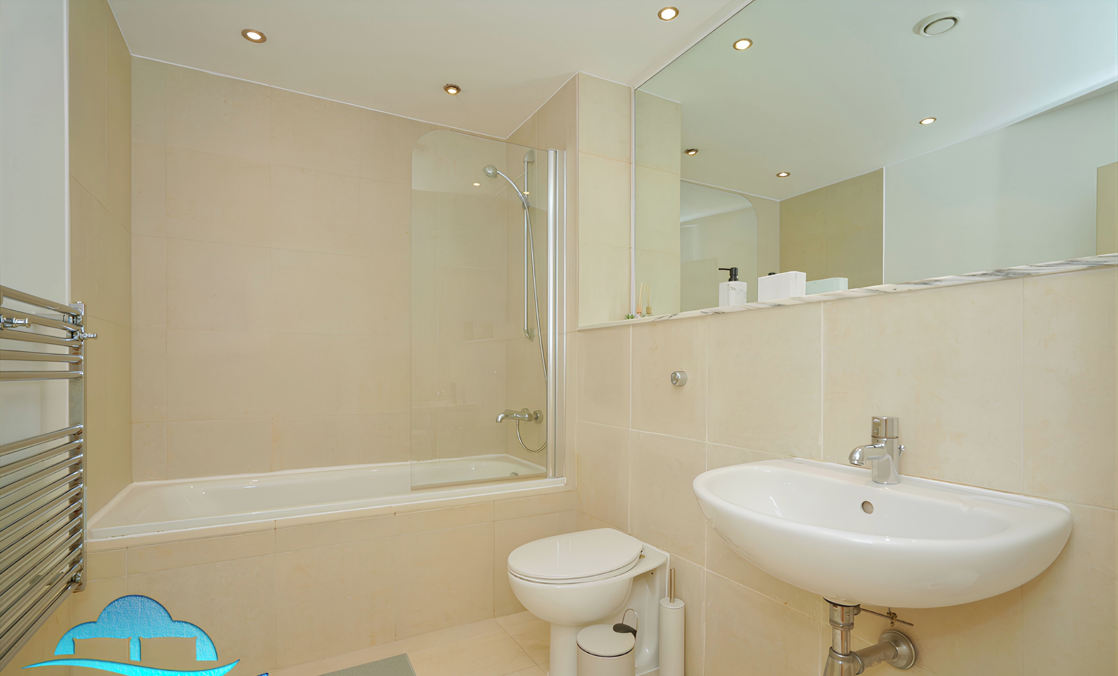 A modern bathroom with a bathtub, toilet, and sink.