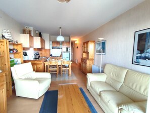 Cozy living space with a kitchenette, dining table, and comfortable seating area.