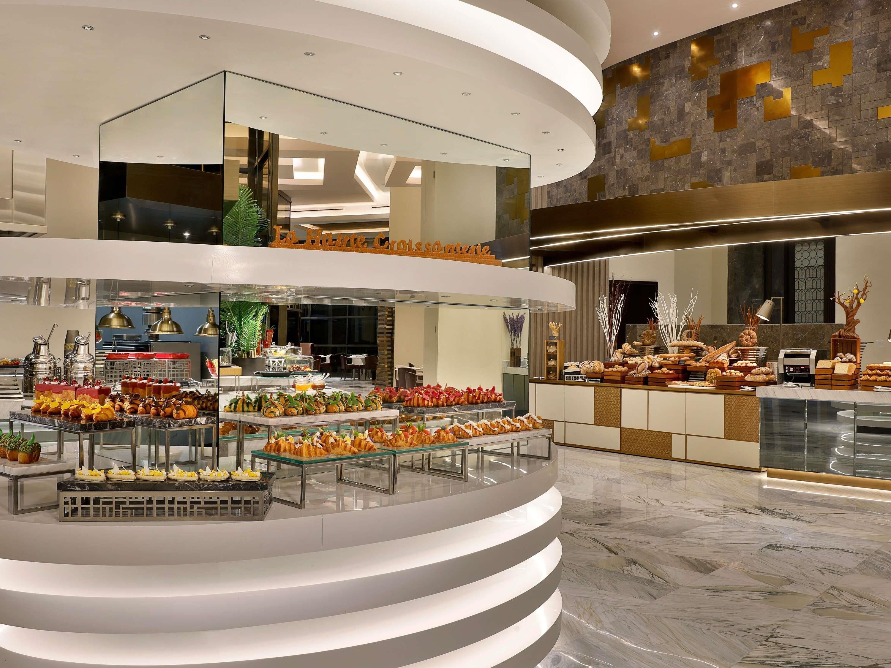 A multi-level breakfast buffet with various food items and a modern interior design.