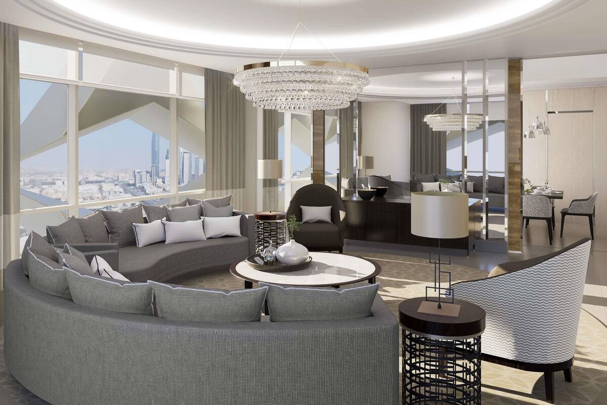 A modern living room with a curved sofa, a round coffee table, and a dining area with chairs and a table.