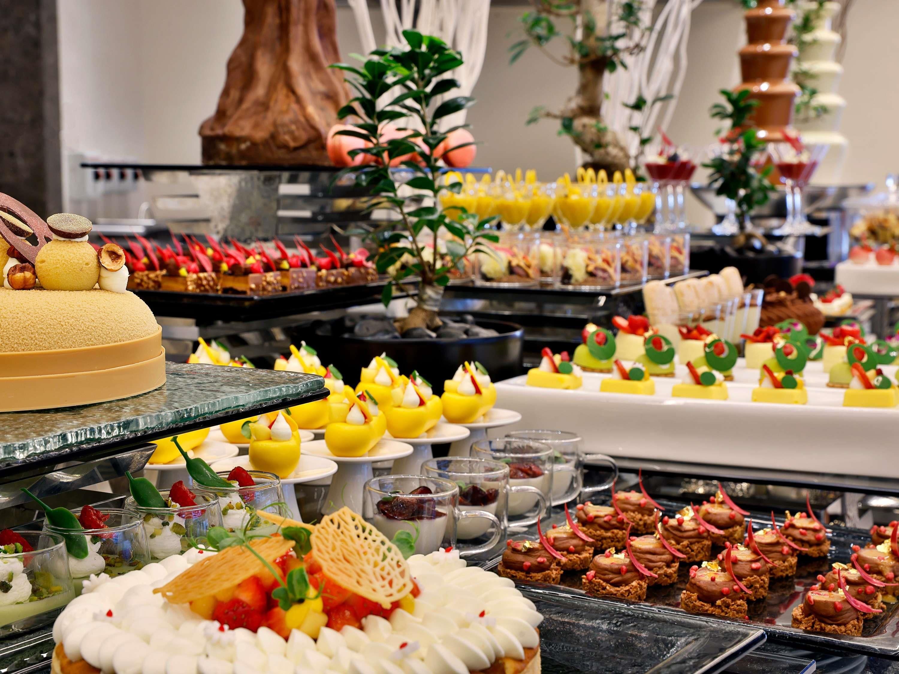A buffet with various food items, including desserts and appetizers.