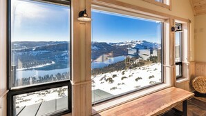 A room with large windows offering a view of a snowy landscape and a lake. - MilkyWay_Lake Views! Air Conditioning, 3850SqFt, 3 Story, Game Room + HOA Amenities (Truckee)