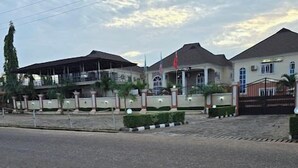 A residential area with houses, a gated entrance, and a clear sky. - Suitoria Hotels  (Ilorin)