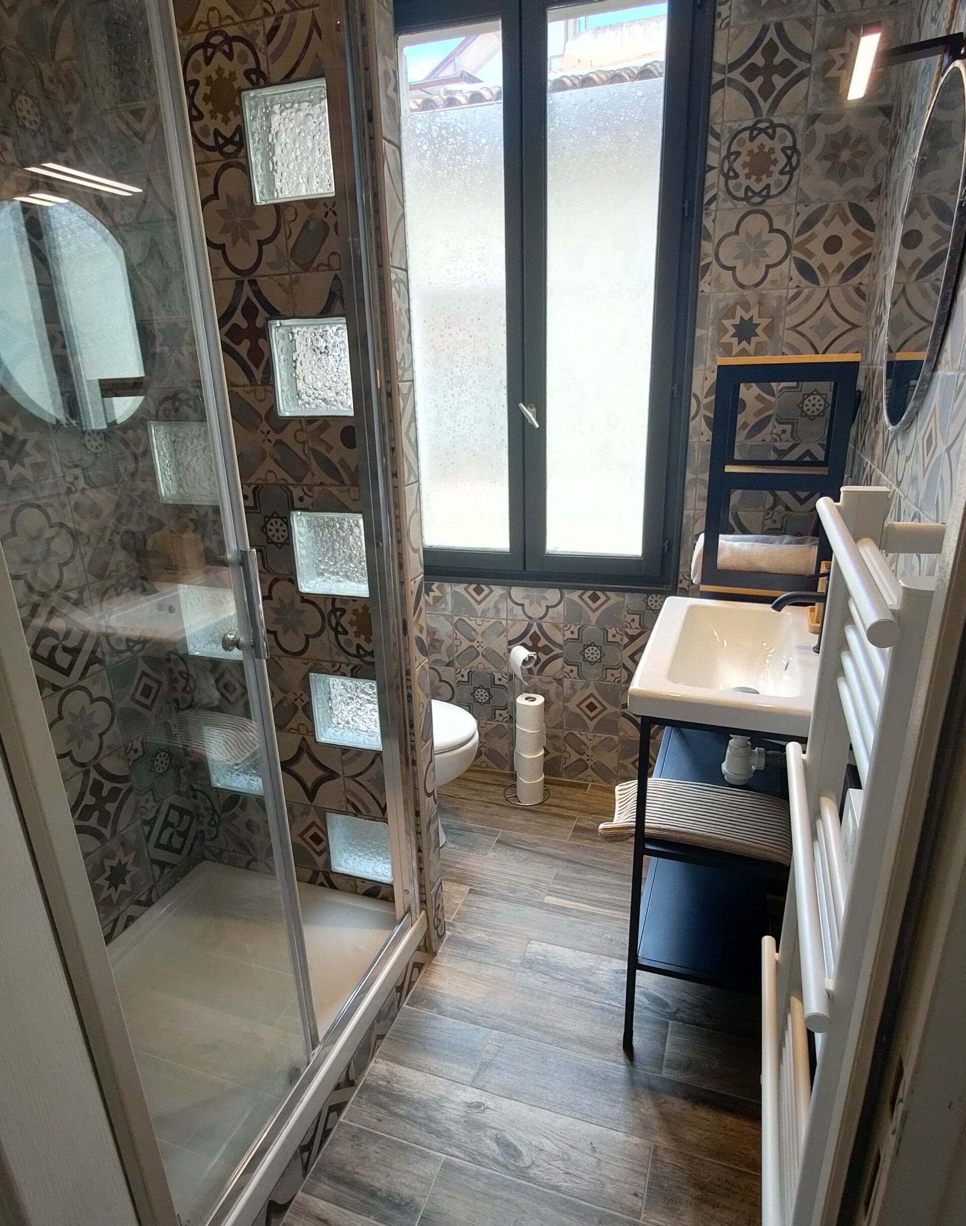 A bathroom with a shower, toilet, and sink.