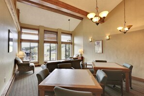 Enjoy meals at the large dining table surrounded by six chairs, with a smaller table for additional seating.