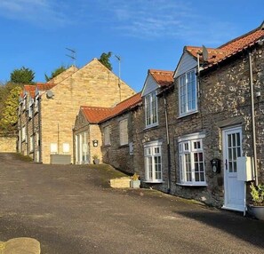Traditional buildings line the historic street, offering a sense of community and continuity.