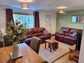 Relax in this stylish living room with a leather sofa, coffee table, and flat-screen TV.