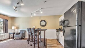 A compact living space with a dining area, kitchen, and seating.
