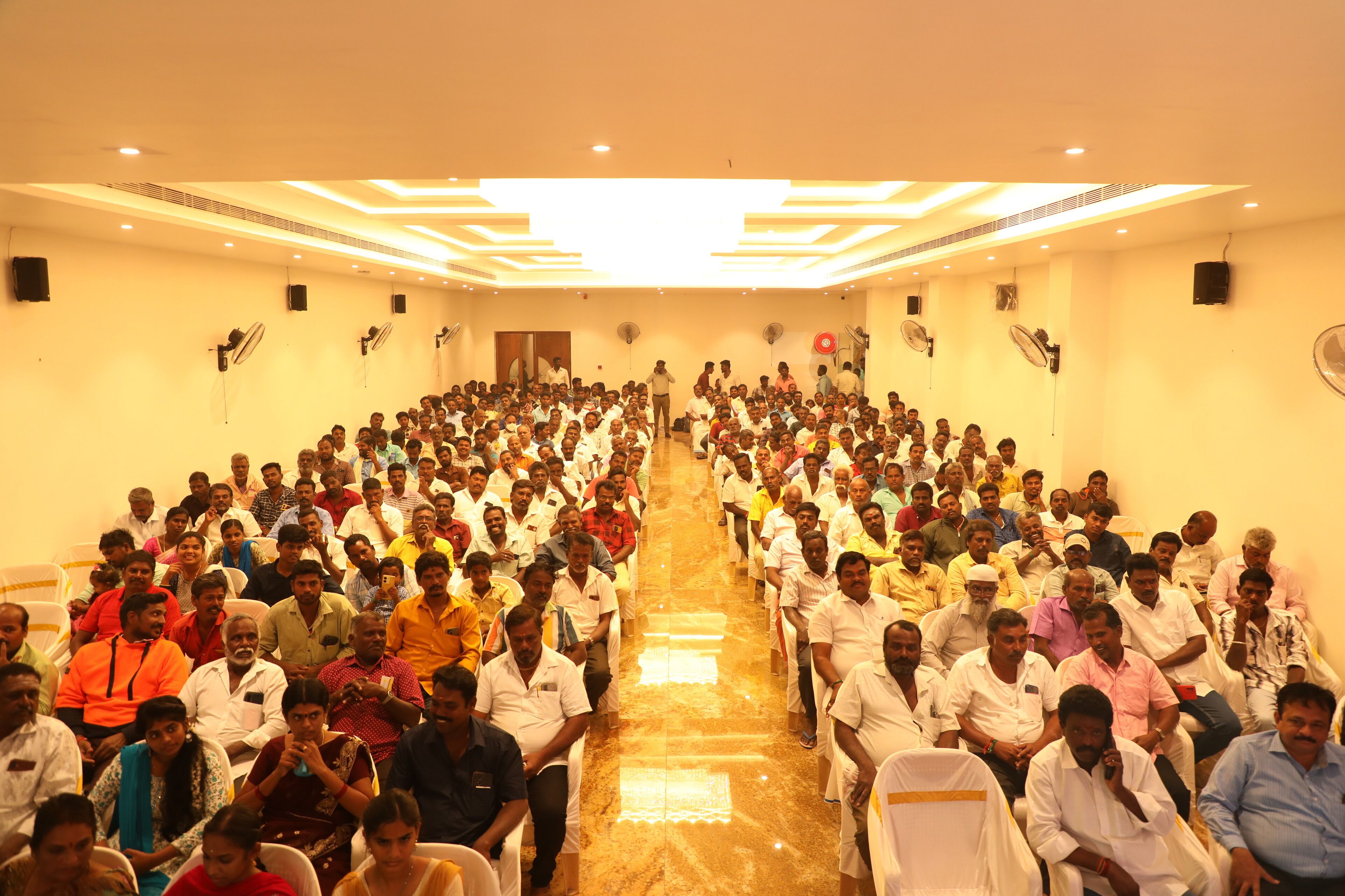 A large hall with rows of chairs arranged for an audience.