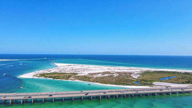 A coastal highway with a bridge over water, leading to a beach area with clear turquoise waters and a sandy shore. - Beach House~Pet Friendly~Private Pool~Sleeps 14~3min walk to the Beach (Destin)