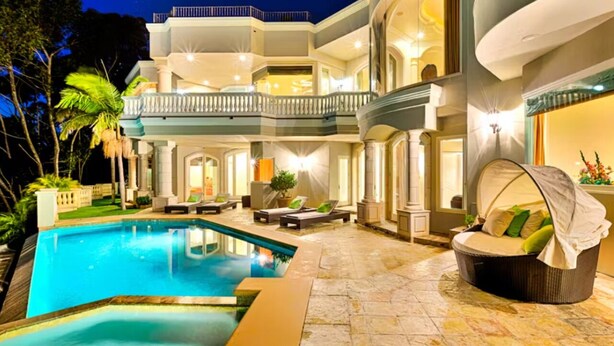 A luxurious poolside area with a large pool, outdoor seating, and a well-lit balcony. - Private Pool/Spa/Open October/Sauna/Amazing La Jolla Views (La Jolla)
