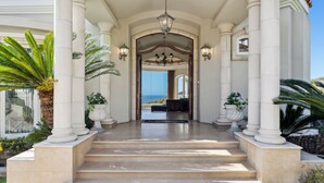 A grand entrance with white columns, a chandelier, and a view of the ocean. - Private Pool/Spa/Open October/Sauna/Amazing La Jolla Views (La Jolla)