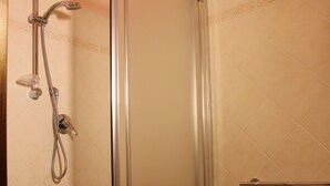 A bathroom with a glass-enclosed shower, a pedestal sink, and tiled walls. - Cozy mini-apartment ideal for a couple. (Tropea)