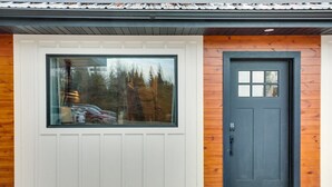 A modern building with a large window and a dark door. - Suite 3 – The Harris Inn in Harrison Hills (Tomahawk)