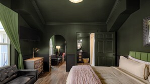Une chambre à coucher avec un lit, un canapé, une commode et un miroir.