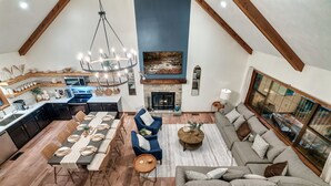 A spacious living area with a fireplace, dining table, and seating.