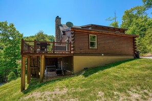 A log cabin with a deck, a chimney, and a satellite dish. - Waccabuck | 17.5 Private Acres, Pool, Hot Tub (Logan)
