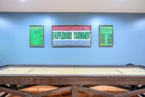 A shuffleboard table with two signs above it. - Sandstone Valley Estate | Hocking, Indoor Pool (Logan)