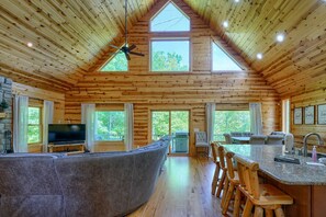 A spacious cabin with a large living area, a kitchen, and a dining area. - Sandstone Valley Estate | Hocking, Indoor Pool (Logan)