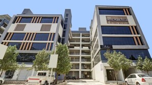 A modern hotel with a prominent sign reading "HOTEL PEARL VILLA Collection". - Pearl Villla Hotel (Gandhinagar)