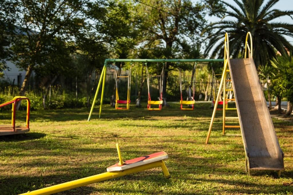 A playground with swings and a slide.