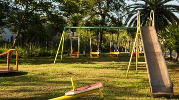 A playground with swings and a slide.