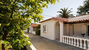 Calle residencial con casas de techos de tejas, paredes blancas y balcones.