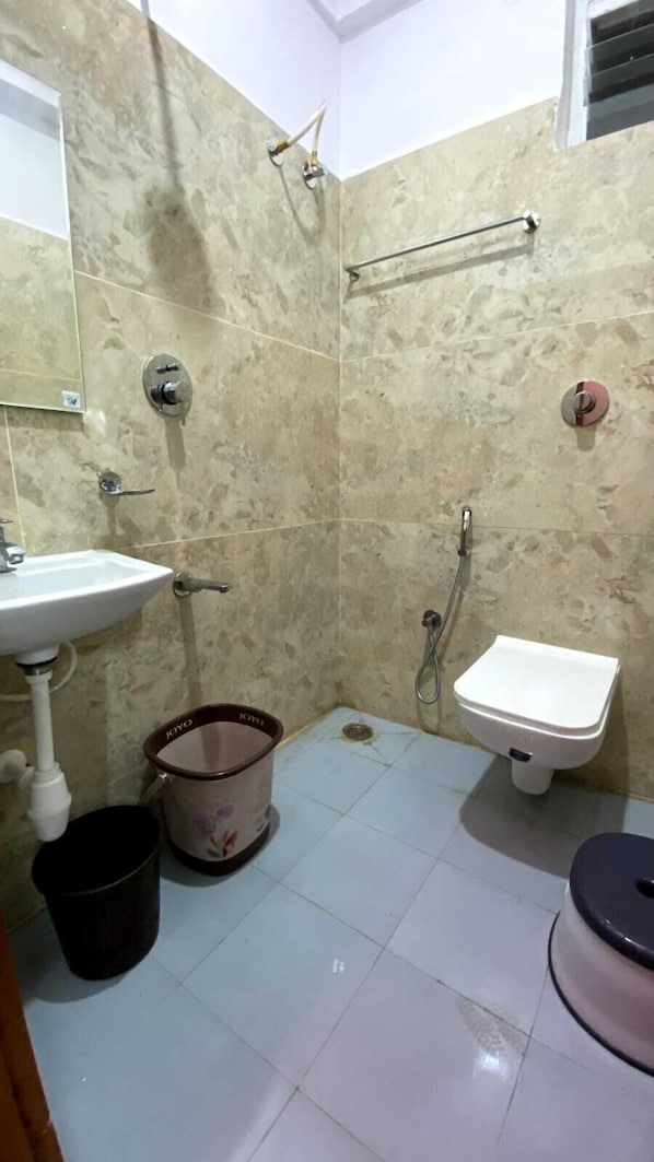 A bathroom with a sink, toilet, and shower. - HKP Residency (Bengaluru)