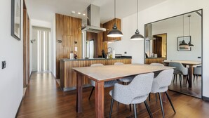 A modern kitchen with wooden cabinetry, a central island, and pendant lighting. - Zacatecas 4 by Wynwood House  (Mexico City)