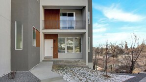 Un bâtiment moderne à deux étages, doté d’un toit plat, de grandes fenêtres et d’un balcon.