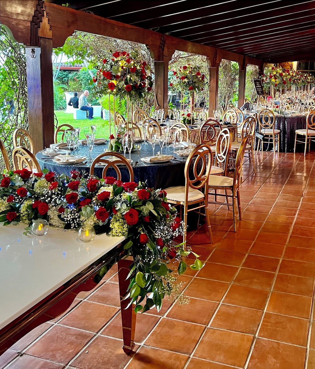Une salle de banquet où les tables sont dressées pour un événement formel, avec des compositions florales et une décoration de table élégante.