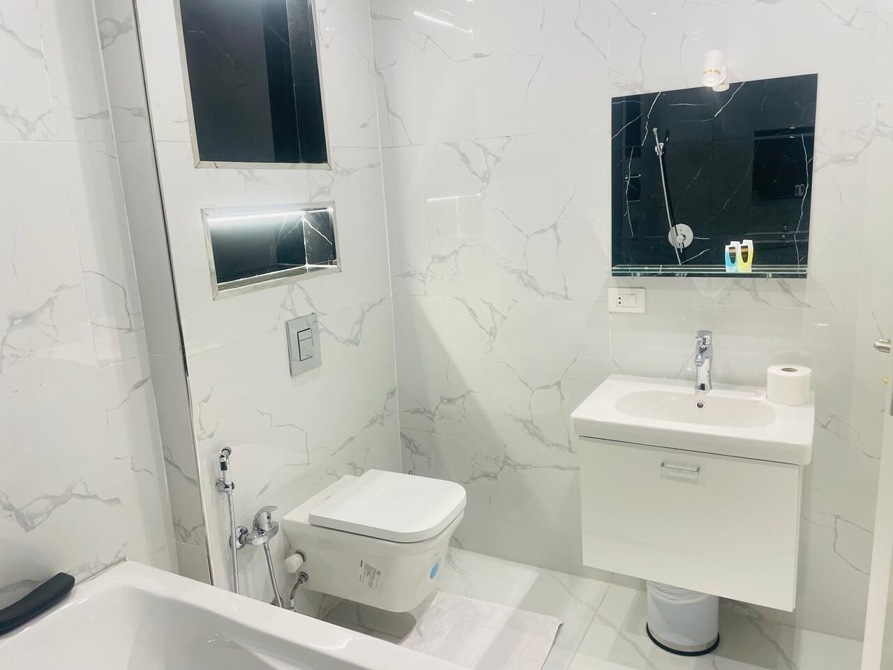 A bathroom with a bathtub, toilet, and sink.