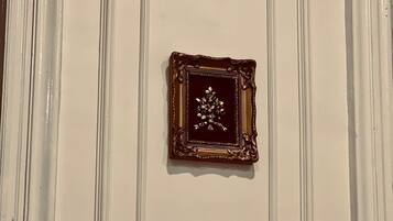 A wall with three decorative plaques, each with a different design, mounted in a vertical arrangement.