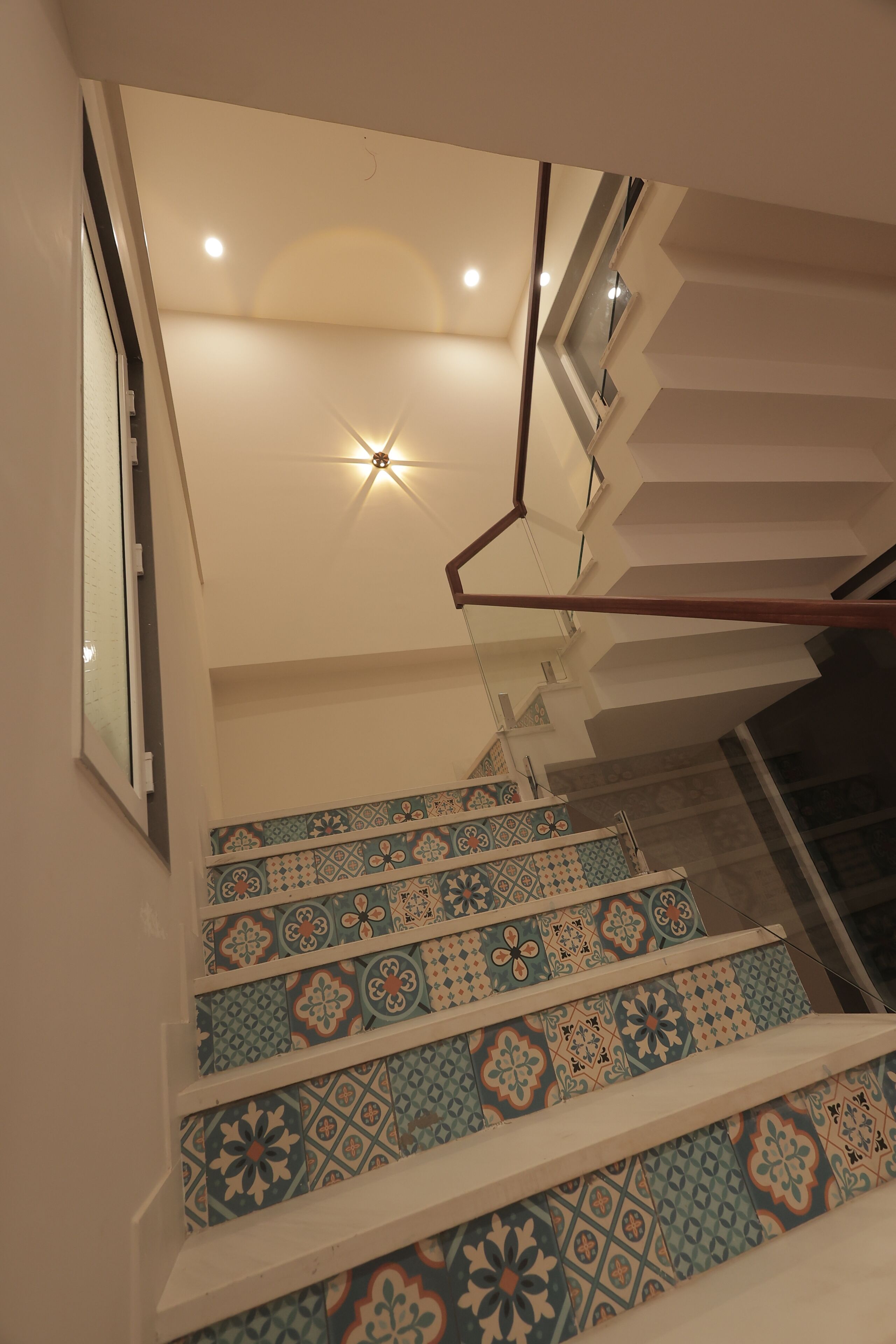 A staircase with patterned tiles and a modern design.