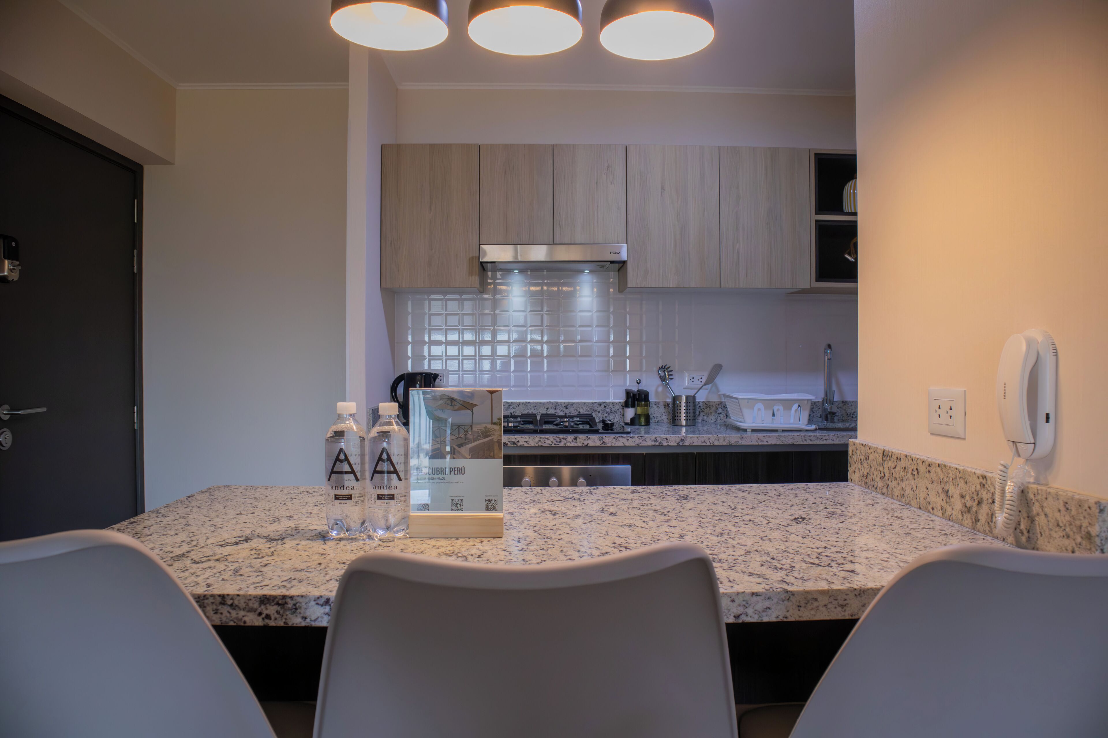 A modern kitchen with granite countertops, stainless steel appliances, and wooden cabinets.