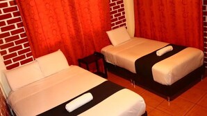 Two single beds with white linens and black headboards in a room with red curtains and brick-patterned walls. - BackpackerKilla (Machu Picchu)