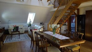 A spacious loft with a dining area, a staircase, and a kitchen. - Enchanted Misty Valley Cottage Apartments - Standard One Bedroom Apartment (Sentjost nad Horjulom)