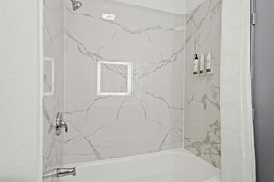 Separate tub and shower, hair dryer, towels, soap