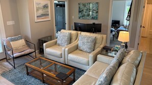 A living room with a sofa set, a coffee table, and a TV.