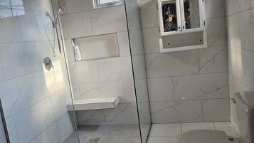 Shower, towels, soap, toilet paper