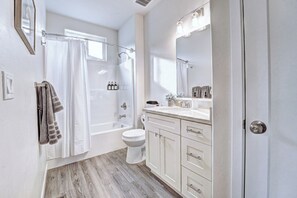 A modern bathroom with a bathtub, toilet, and vanity. - San Juan Reflections Getaway 3B/2Ba, Pet Friendly & Game Room  (Montrose)