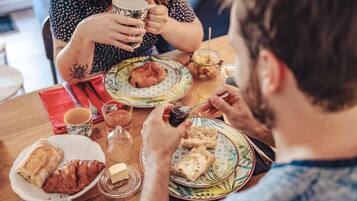 A dining table with plates of food, a cup, and a glass of water.