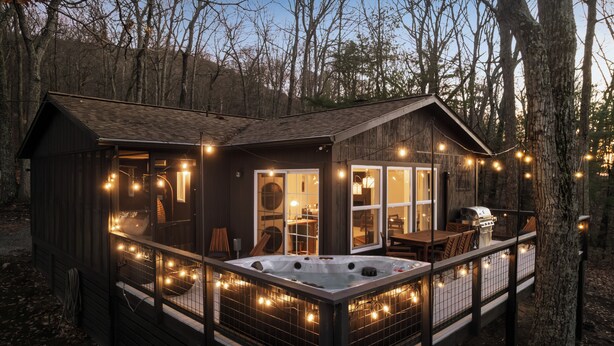 A cabin with a hot tub, deck, and string lights. - 25% Off ~ Hygge mountain retreat w/ stunning views (New Market)