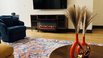 Smart TV, fireplace, books, printers