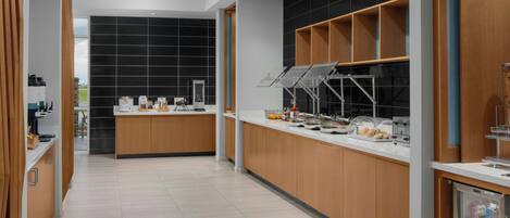 A modern kitchen with wooden cabinets, a black backsplash, and a stainless steel refrigerator.