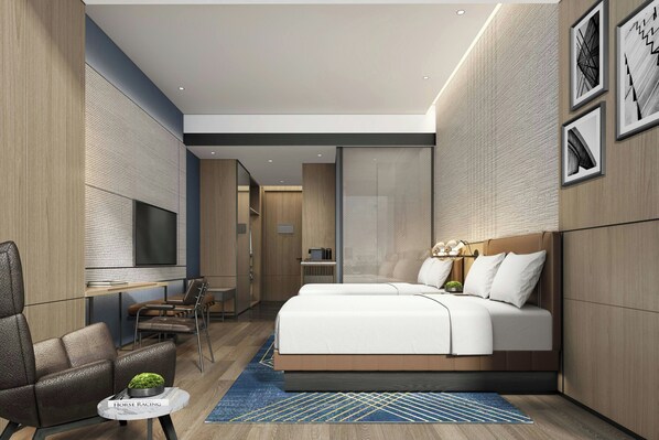 Una habitación de hotel moderna con una cama grande, un área de descanso con televisor y una pequeña mesa con un adorno.